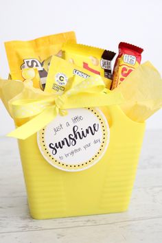 a yellow bucket filled with candy and snacks