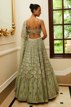 Mint green attached cancan flared lehenga with all-over scallop spark tonal embroidery highlighted with sequin, silver beads and crystals. Paired with sweetheart neck cut out detail embellished sleeveless padded blouse and scallop embroidered net dupatta.
Components: 3
Pattern: Embroidery
Type Of Work: Tonal Silver Beads, Sequins, Crystals
Neckline: Sweetheart Neck
Sleeve Type: Strap Sleeves
Fabric: Net, Raw Silk
Color: Green
Other Details: 
Attached cancan
Padded blouse
Blouse with bead drops
A Designer Embellished Green Lehenga, Green Bollywood Embellished Lehenga, Green Bollywood Lehenga Embellished, Green Bollywood Style Embellished Lehenga, Green Hand Embellished Dupatta For Wedding, Bollywood Style Green Embellished Lehenga, Hand Embellished Green Dupatta For Wedding, Green Hand-embellished Wedding Dupatta, Green Embellished Lehenga For Reception