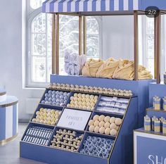 a display case filled with lots of different types of cookies and other items in front of a window