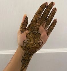 a woman's hand with henna on it