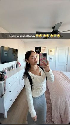 a woman taking a selfie in her bedroom with the text back to school today