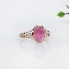 This exquisite cocktail ring showcases a stunning 2.78 carat oval Pink Tourmaline gemstone set in a split shank design with natural earth mined diamonds adding a touch of elegance and sophistication. The gemstone is elegantly framed in a bezel setting. Perfect for making a statement, this ring is both bold and refined. This Pink Tourmaline ring also makes a lovely October birthstone for your loved ones! This ring is made with solid 14K Gold and natural Earth mined SI / G-H diamonds. As listed, t Oval Tourmaline Halo Setting Jewelry, Oval Tourmaline Jewelry With Halo Setting, Oval Rose Gold Tourmaline Ring, Rose Gold Oval Tourmaline Rings, Pink Tourmaline Ring, Jewelry Appraisal, Solitaire Studs, Tourmaline Ring, Split Shank