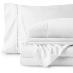 the white sheets and pillows are neatly folded on top of each other in this bedding set