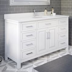 a white bathroom vanity sitting under a mirror