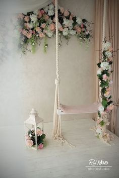 a white hammock with pink and white flowers hanging from it