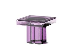 a purple glass table sitting on top of a white floor