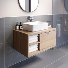 a bathroom with a sink, mirror and shower