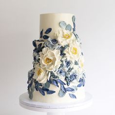 a white cake with blue and yellow flowers on it