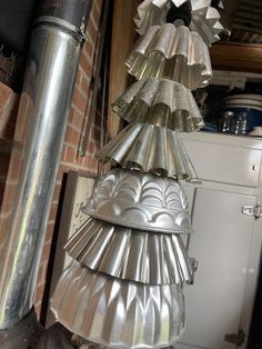 a metal christmas tree made out of tinfoil