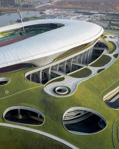 an aerial view of a building with grass on the ground