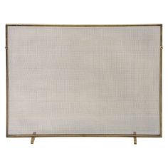 a white fire screen sitting on top of a wooden stand with an iron frame and two legs