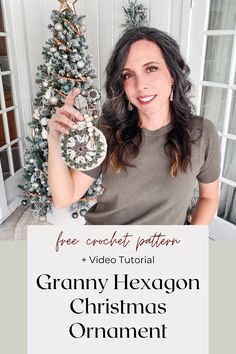 a woman holding up a christmas ornament in front of a tree with the words granny hexgon christmas ornament on it