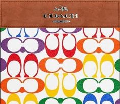 the coach wallet is multicolored and has multiple letters on it