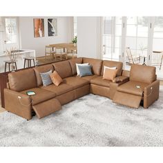 a living room with a large sectional couch and lots of pillows on the rugs