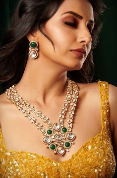 Introducing an exquisite double-layer Kundan necklace adorned with radiant Kundan stones, accompanied by matching earrings, all set in mixed metal with opulent 22kt gold plating, offering an enchanting blend of tradition and elegance. Finish: 22KT Gold Plating Material: Brass, Kundan Color: Gold, Green & White Size: Free Size, Adjustable Closure Type: Draw String Box Contains: 1 Necklace, 1 Pair of Earrings Kundan Yellow Gold Jewelry For Diwali, Fusion Gold Jewelry Sets For Diwali, Diwali Kundan Yellow Gold Jewelry, Fusion Gold Bridal Necklace For Diwali, Fusion Style Gold Bridal Necklace For Diwali, Elegant Gold Kundan Necklace With Meenakari, Heavy Elegant Gold-plated Kundan Necklace, Fusion Style Gold Bridal Necklace Hand Set, Gold Fusion Bridal Necklace Hand Set