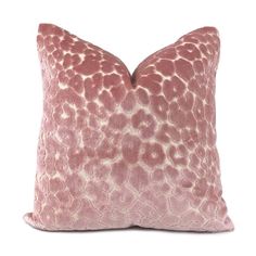 a pink and white pillow with an animal print pattern on the front, sitting on a white background