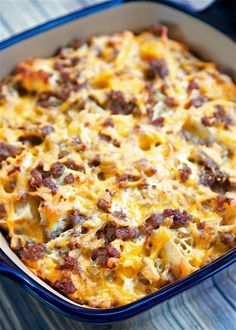 sausage mac and cheese casserole in a blue dish