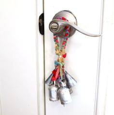 a door handle with bells attached to it