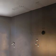 a room with several lights hanging from the ceiling