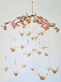 a wind chime with flowers and butterflies hanging from it