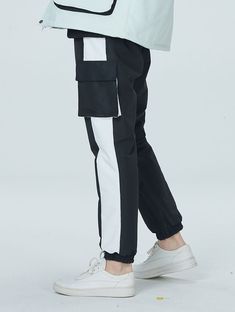 a person wearing white sneakers and black pants