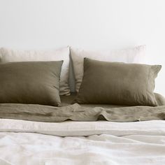 a bed with two pillows on top of it