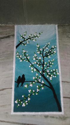 a painting with two birds sitting on a tree branch in front of blue sky and white flowers