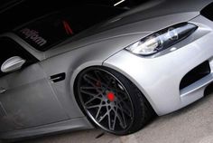 the front end of a silver sports car