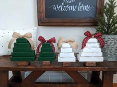 christmas decorations on a table in front of a welcome home sign