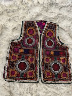 Stepping back in time with this vintage unisex Afghan/uzbek waistcoat. Every stitch tells a story, every pattern a piece of history. Handmade. Vintage. - Sizes available: S,M,L Vintage Sleeveless Outerwear For Festivals, Vintage Handmade Festival Outerwear, Bohemian Sleeveless Embroidered Outerwear, Festive Bohemian Vest, Folk Style Multicolor Festival Vest, Handmade Folk Style Vest For Festivals, Handmade Folk Vest For Festivals, Traditional Embroidered Sleeveless Outerwear, Handmade Bohemian Vest For Festival