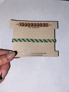 a hand holding a business card with an arrow on it