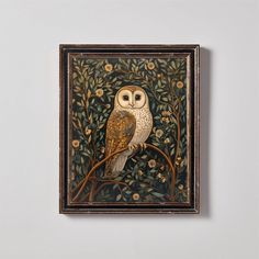 an owl sitting on top of a tree branch in front of a white wall with flowers