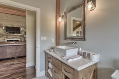 a bathroom with a sink, mirror and toilet