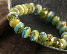 "A highly dimensional strand of beads with a tropical vibe. Czech glass fire polished rondelles in Parakeet color way with Picasso finish are a delight to the eye. Try adding to beach-ready bracelet stacks, tropical earring looks, and boho bead link chains.  Sold as: 6\" strand (25 beads per strand) All Czech glass in our shop is authentic, artisan-made glass from the Czech Republic. From the earliest days, Czech glassmakers set the standard for the world. Today, it's still a cottage industry, driven by small business owners and families creating beads with time-tested techniques. The never-ending supply of vibrant colors, iconic shapes, and fanciful finishes means there's always something new to captivate us. We pick our favorites, check them for quality and consistency, and pass them on Parakeet Colors, Czech Beads Jewelry, Tropical Earrings, Bracelet Stacks, Beads Online, Bead Store, Beach Ready, Tropical Vibes, Czech Beads