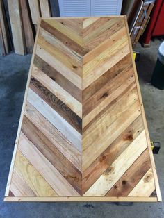 a wooden table top sitting inside of a garage