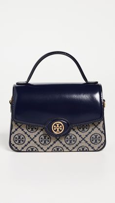 Find TORY BURCH T Monogram Spazzolato Top Handle Satchel on Editorialist. Jacquard. Leather trim. Monogram pattern. Gold-toned hardware. Structured base with metal feet. Zip at top. Patch interior pocket. Optional, adjustable strap. Suede lining. Weight: 11oz / 0.31kg. Imported, Vietnam. Measurements: Height: 4.75in / 12cm Length: 7.5in / 19cm Depth: 4.25in / 11cm Strap drop: 21.75in / 55cm Handle drop: 2.25in / 6cm Top Handle, Leather Trims, Adjustable Straps, Tory Burch, Satchel, Monogram, Navy, Luxury Fashion, Leather