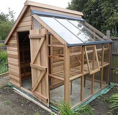 a small wooden building with a glass roof