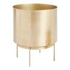 a round brass planter on a white background