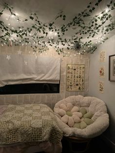 a bed with pillows and lights hanging from the ceiling in a room that is decorated with ivy