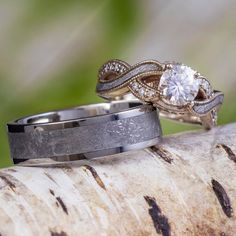 two wedding rings sitting on top of a tree branch