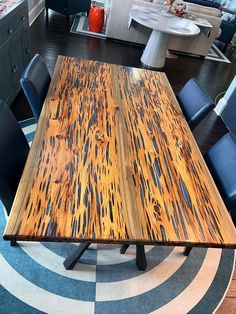 a wooden table with blue chairs around it