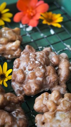 there are some cookies and flowers on the cooling rack