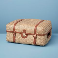 an old suitcase sitting on top of a blue surface