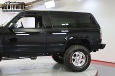 a black truck is parked in a garage