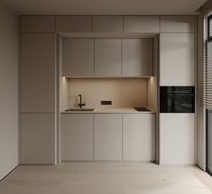 an empty kitchen is shown with white cabinets and counter tops, as well as a window