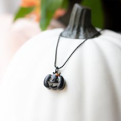 Illuminate your Halloween with our Black Jack-O'-Lantern Capsule Locket Necklace. This unique locket necklace features a charming pumpkin Jack-O'-Lantern design, capturing the spirit of the season. Add this statement locket necklace to your collection and let this GOURD-eous piece accompany you on all your spooky adventures. Halloween Themed Black Necklace, Black Themed Necklace For Halloween, Themed Black Necklace For Halloween, Adjustable Black Themed Necklace, Black Halloween Necklace With Lobster Clasp, Black Halloween Jewelry With Adjustable Chain, Spooky Black Necklace For Gift, Spooky Adjustable Black Jewelry, Adjustable Black Spooky Jewelry