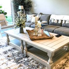 a living room filled with furniture and a rug on top of a carpeted floor