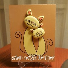 a card with two cats hugging each other