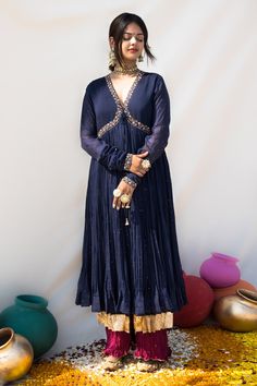 Blue mul chanderi jacket style kurta with meena zardosi hand embroidered neckline and pure lampi work on edges.
Components: 1
Pattern: Hand embroidered
Type Of Work: Meena zardosi
Neckline: V Neck
Sleeve Type: Churidar Sleeves
Fabric: Mul chanderi, Lining : Mulmul
Color: Blue
Other Details: 
Chinta and mukaish work all over
Closure : Tie-up with tassels
Note : Pant worn by the model is not for sale.
Disclaimer : The natural imperfection and textures in the weaves are the outcome of handloom fabr V Neck Churidar, Churidar Sleeves, Mukaish Work, Black Lehenga, Tunics Online, Kurta For Women, Handloom Fabric, Embroidered Neckline, Fashion App