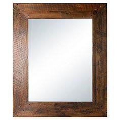 a wooden frame mirror hanging on the wall